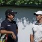 Patrick Reed, left, and Rory McIlroy, right, talk on the first tee during practice at the Tour Championship golf tournament on Wednesday, Sept. 1, 2021, at East Lake Golf Club in Atlanta. (AP Photo/Brynn Anderson) **FILE**