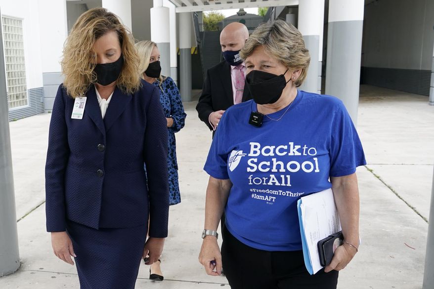 In this file photo, American Federation of Teachers President Randi Weingarten, right, speaks with Broward County Schools interim superintendent Vickie Cartwright, left, while visiting the New River Middle School, Thursday, Sept. 2, 2021, in Fort Lauderdale, Fla. Ms. Weingarten has said its Republican politicians campaigning on culture war issues that have made teachers out to be &quot;social justice warriors.&quot; (AP Photo/Lynne Sladky)  **FILE**