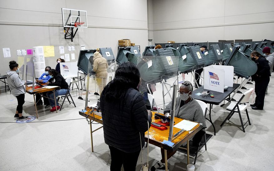 FILE - Voters cast their ballots for the general election at Victory Houston polling station, one of the Harris County's 24-hour locations, in Houston, on Friday, Oct. 30, 2020. Texas has become the latest state where Republicans have rolled back access to voting methods that soared in popularity during last year’s pandemic presidential election. Following similar legislation in Arizona, Florida, Georgia, Iowa and some other GOP-controlled states, Texas Republicans passed new restrictions on mail-in balloting as well as bans on 24-hour polling places and drive-thru voting. (Elizabeth Conley/Houston Chronicle via AP, File)