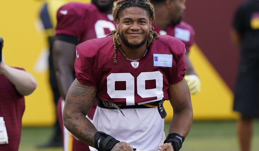 Washington Football Team defensive end Chase Young smiles during the NFL football team&#x27;s practice Friday, Aug. 6, 2021, in Landover, Md. (AP Photo/Alex Brandon)