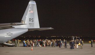 In this Aug. 29, 2021, photo, families evacuated from Kabul, Afghanistan, walk past a U.S Air Force plane that they arrived on at Kosovo&#39;s capital Pristina International Airport. The Afghans came from the Ramstein military base in Germany, and they will be housed near the U.S. military Camp Bondsteel, 40 kilometers (25 miles) south of the capital Pristina. (AP Photo/Visar Kryeziu) **FILE**