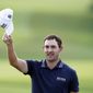 Patrick Cantlay tips his cap to the crowd after winning the Tour Championship golf tournament and the FedEx Cup at East Lake Golf Club, Sunday, Sept. 5, 2021, in Atlanta. (AP Photo/Brynn Anderson)