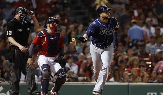 Tampa Bay Rays&#39; Nelson Cruz tosses his bat as he watches his two-run home run during the third inning of the team&#39;s baseball game against the Boston Red Sox on Tuesday, Sept. 7, 2021, at Fenway Park in Boston. (AP Photo/Winslow Townson)