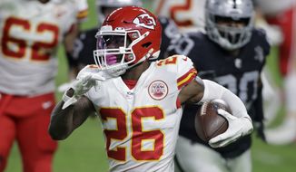 In this Nov. 22, 2020, file photo, Kansas City Chiefs running back Le&#39;Veon Bell (26) carries the ball against the Las Vegas Raiders during the first half of an NFL football game in Las Vegas. The Baltimore Ravens signed Bell to their practice squad, adding another backfield option in the aftermath of J.K. Dobbins season-ending injury. Bell was cut early last season by the New York Jets, then rushed for 328 yards in 11 games with Kansas City. He did not play in the Super Bowl for the Chiefs. (AP Photo/Isaac Brekken, File) **FILE**