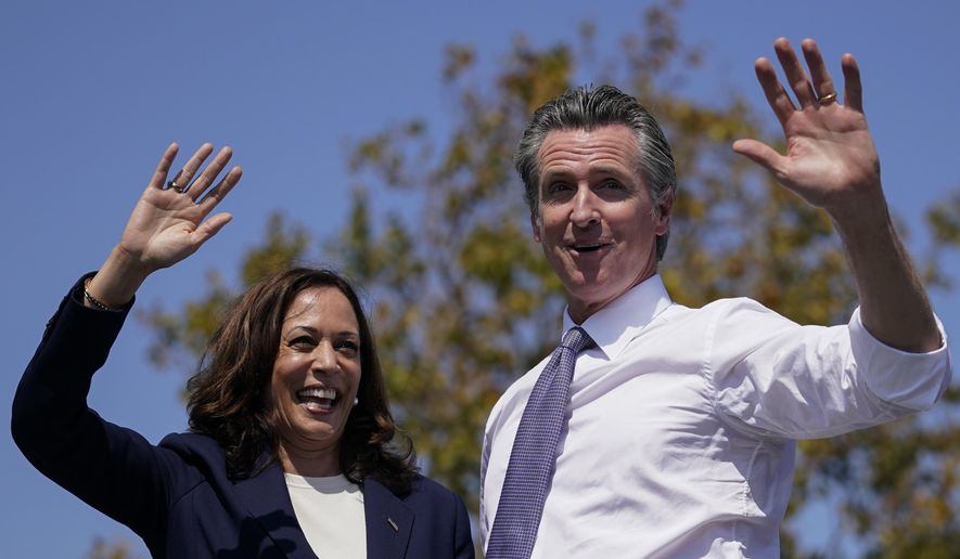 Vice President Kamala Harris stands on stage with California Gov. Gavin Newsom at the conclusion of a campaign event at the IBEW-NECA Joint Apprenticeship Training Center in San Leandro, Calif., Wednesday, Sept. 8, 2021. (AP Photo/Carolyn Kaster)