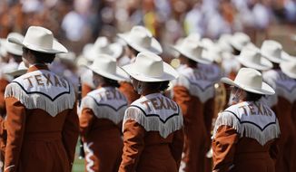 In this Saturday, Sept. 4, 2021, file photo, the Texas band take the field to perform before an NCAA college football between Texas and Louisiana-Lafayette in Austin, Texas.  The Texas chapter of the NAACP and a group of UT students have filed a federal civil rights complaint against the University of Texas for its continued use of “The Eyes of Texas” school song, tune with racist elements in its past. The complaint filed Friday, Sept. 3, 2021, with the U.S. Department of Education alleges that Black students and faculty are being subjected to violations of the Civil Rights Act and a hostile campus environment. (AP Photo/Eric Gay) **FILE**