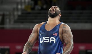 In this Aug. 6, 2021, file photo, United States&#39; Gable Dan Steveson celebrates after defeating Georgia&#39;s Gennadij Cudinovic during their men&#39;s freestyle 125kg wrestling final match at the 2020 Summer Olympics in Chiba, Japan. Steveson has achieved his childhood dream of signing with World Wrestling Entertainment, but with a twist. The WWE announced Thursday that it has signed Steveson to an exclusive NIL deal that will allow him to join the WWE roster and return to the University of Minnesota to defend his college heavyweight wrestling title. It is the WWE’s first NIL deal. (AP Photo/Aaron Favila, File) **FILE**
