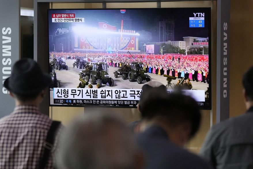 People watch a TV showing a military parade held in Pyongyang, North Korea, at Seoul Railway Station in Seoul, South Korea, Thursday, Sept. 9, 2021. North Korea paraded goose-stepping soldiers and military hardware in its capital overnight in a celebration of the nation's 73rd anniversary that was overseen by leader Kim Jong-un, state media reported Thursday. (AP Photo/Ahn Young-joon)