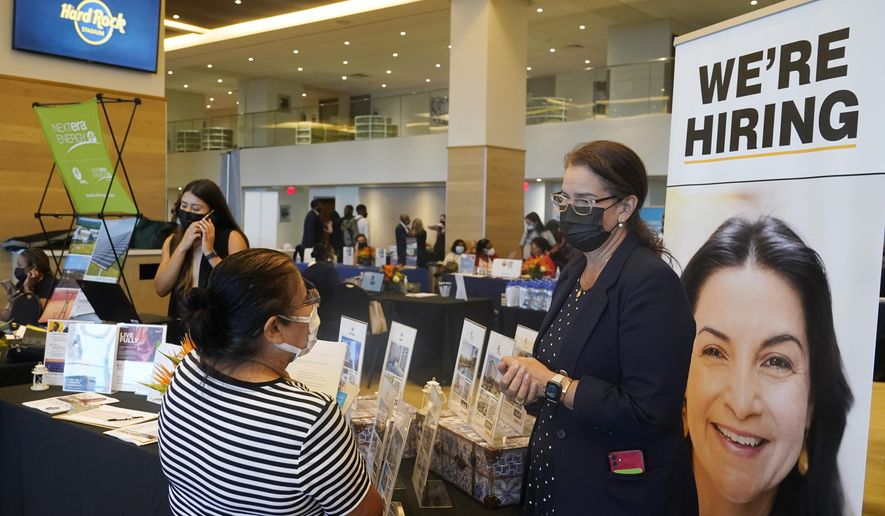Marriott human resources recruiter Mariela Cuevas, left, talks to Lisbet Oliveros, during a job fair at Hard Rock Stadium, Friday, Sept. 3, 2021, in Miami Gardens, Fla.  The number of Americans seeking unemployment benefits fell sharply last week to 310,000, a pandemic low and a sign that the surge in COVID-19 cases caused by the delta variant has yet to lead to widespread layoffs. (AP Photo/Marta Lavandier)