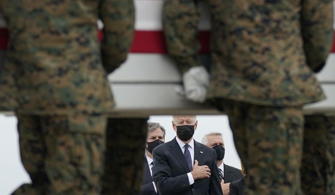 President Joe Biden watches as a carry team moves a transfer case containing the remains of Marine Corps Lance Cpl. Kareem M. Nikoui, 20, of Norco, Calif., during a casualty return Sunday, Aug. 29, 2021, at Dover Air Force Base, Del. According to the Department of Defense, Nikoui died in an attack at Afghanistan&#x27;s Kabul airport, along with 12 other U.S. service members. (AP Photo/Carolyn Kaster) **FILE**