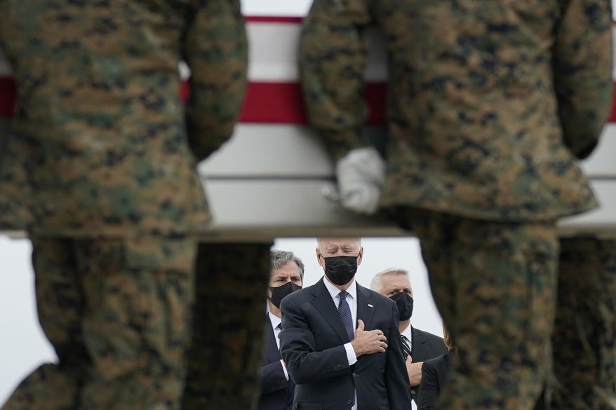 President Joe Biden watches as a carry team moves a transfer case containing the remains of Marine Corps Lance Cpl. Kareem M. Nikoui, 20, of Norco, Calif., during a casualty return Sunday, Aug. 29, 2021, at Dover Air Force Base, Del. According to the Department of Defense, Nikoui died in an attack at Afghanistan&#39;s Kabul airport, along with 12 other U.S. service members. (AP Photo/Carolyn Kaster) **FILE**