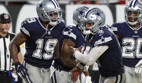 Dallas Cowboys quarterback Dak Prescott (4) celebrates with wide receiver Amari Cooper (19) after Cooper caught a 21-yard touchdown reception during the second half of an NFL football game against the Tampa Bay Buccaneers Thursday, Sept. 9, 2021, in Tampa, Fla. (AP Photo/Scott Audette)
