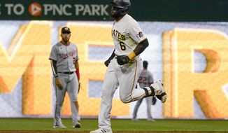 Pittsburgh Pirates&#39; Anthony Alford (6) runs the bases in front of Washington Nationals second basemen Luis Garcia after hitting a solo home run during the seventh inning of a baseball game Friday, Sept. 10, 2021, in Pittsburgh. (AP Photo/Keith Srakocic)
