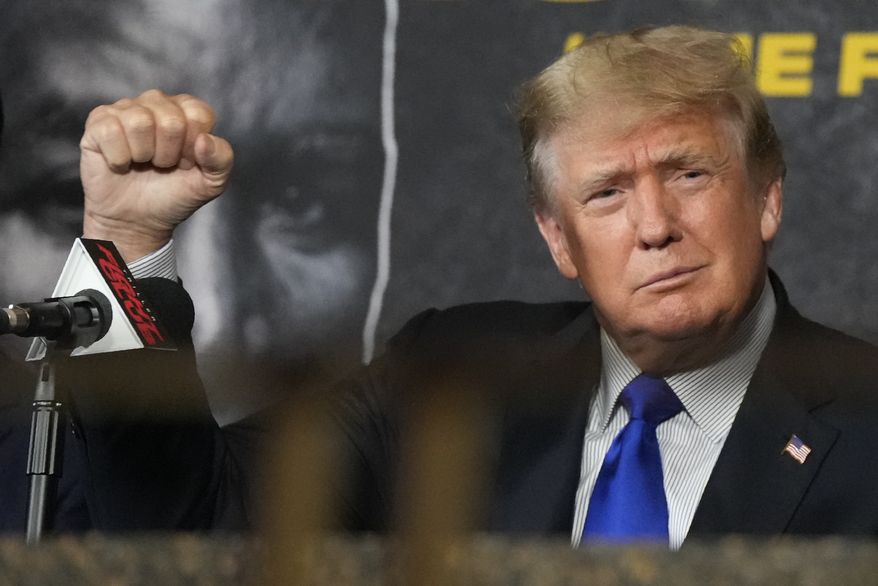 Former President Donald Trump salutes cheering fans as he prepares to provide commentary for a boxing event headlined by a bout between former heavyweight champ Evander Holyfield and former MMA star Vitor Belfort, Saturday, Sept. 11, 2021, in Hollywood, Fla. (AP Photo/Rebecca Blackwell) **FILE**