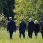 President Joe Biden and first lady Jill Biden walk with Gordon Felt, brother of Edward Porter Felt and President of Families for Flight 93, second from left, and Calvin Wilson the brother-in-law of First Officer LeRoy Homer, a passenger on Flight 93, second from right, to visit a boulder marking the impact site of Flight 93 at the Flight 93 National Memorial in Shanksville, Pa., Saturday, Sept. 11, 2021. The Bidens visited to commemorate the 20th anniversary of the Sept. 11, 2001, terrorist attacks. (AP Photo/Evan Vucci)