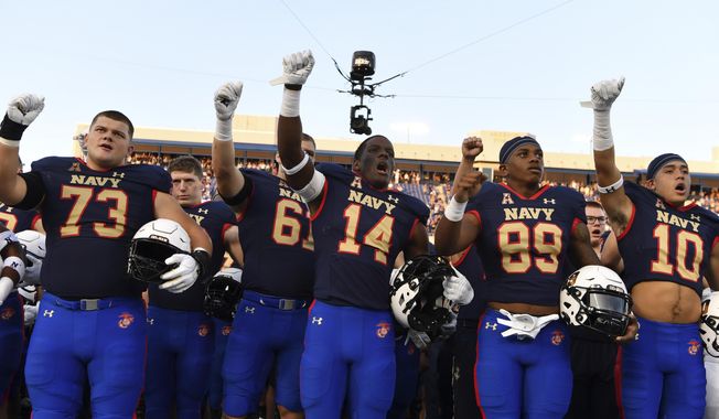 Navy players raise their fists after singing &amp;quot;Navy Blue and Gold&amp;quot; after an NCAA college football game against Air Force, Saturday, Sept. 11, 2021, in Annapolis, Md. (AP Photo/Terrance Williams) ** FILE**