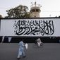 The iconic Taliban flag is painted on a wall outside the American embassy compound in Kabul, Afghanistan, Saturday, Sept. 11, 2021. (AP Photo/Bernat Armangue)