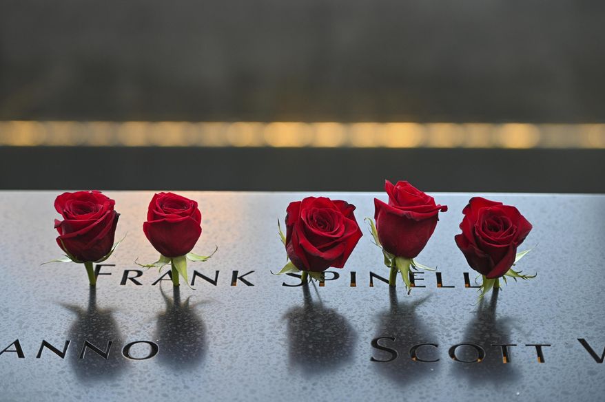 Flowers placed at the name of Frank Spinelli before ceremonies to commemorate the 20th anniversary of the Sept. 11 terrorist attacks, Saturday, Sept. 11, 2021, at the National September 11 Memorial &amp;amp; Museum in New York.  (Anthony Behar, Pool Photo via AP)