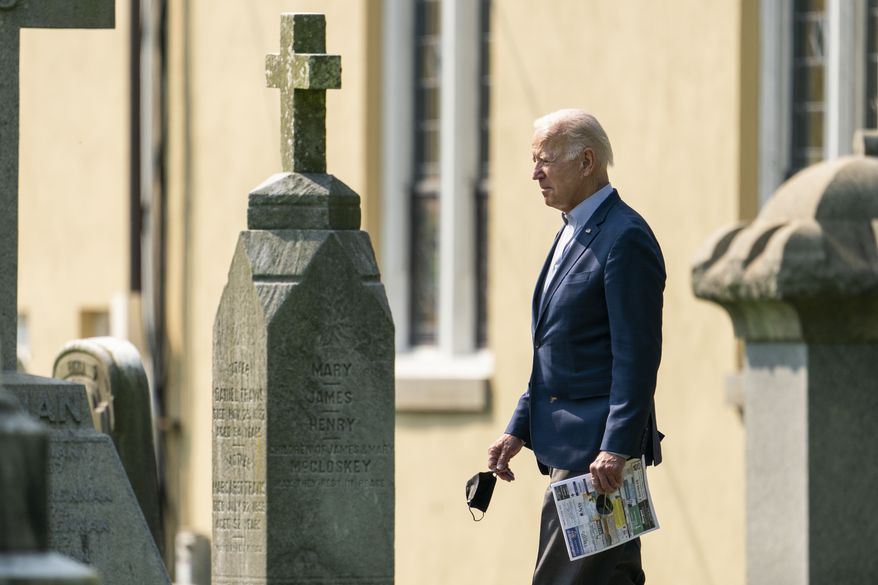 President Joe Biden walks between tombstones as he leaves St. Joseph on the Brandywine Catholic Church in Wilmington, Del., after attending a Sunday Mass, Sunday, Sept. 12, 2021. (AP Photo/Manuel Balce Ceneta)