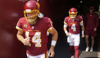 Washington Football Team quarterbacks Ryan Fitzpatrick (14) and Taylor Heinicke (4) take the field for warmups prior to the start of the first half of an NFL football game against the Los Angeles Chargers, Sunday, Sept. 12, 2021, in Landover, Md. (AP Photo/Andrew Harnik)