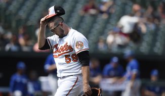 Baltimore Orioles starting pitcher Zac Lowther walks to the dugout after giving up five runs to the Toronto Blue Jays in the first inning of a baseball game Sunday, Sept. 12, 2021, in Baltimore. (AP Photo/Gail Burton)