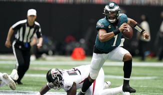 Philadelphia Eagles quarterback Jalen Hurts (1) breaks out of the pocket against the Atlanta Falcons during the first half of an NFL football game, Sunday, Sept. 12, 2021, in Atlanta. (AP Photo/Brynn Anderson)