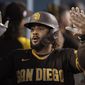 San Diego Padres&#39; Fernando Tatis Jr. is greeted in the dugout after hitting a two-run home run during the fourth inning of the team&#39;s baseball game against the Los Angeles Dodgers in Los Angeles, Saturday, Sept. 11, 2021. (AP Photo/Kyusung Gong)