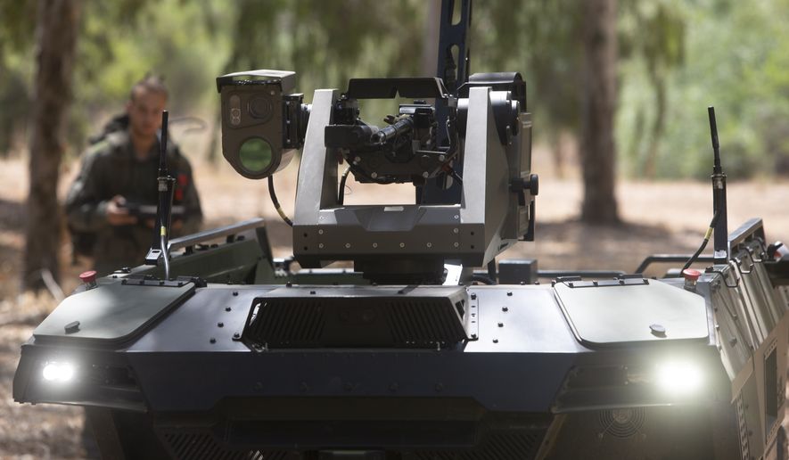 Israel Aerospace Industries' semi-autonomous four-wheel-drive "REX MKII" is seen at an IAI facility near the central Israeli city of Lod, Thursday, Sept. 9, 2021. Israel's state-owned Israel Aerospace Industries unveiled Monday a state-of-the-art unmanned vehicle their specialists said will be deployed alongside ground troops to assist in combat situations. (AP Photo/Sebastian Scheiner)