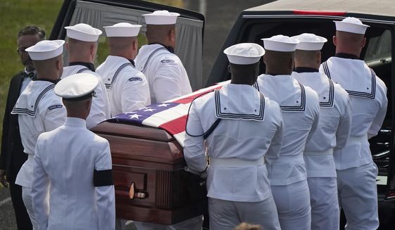 The body of Navy Corpsman Maxton Soviak is put into the hearse at Edison High School Stadium, Monday, Sept. 13, 2021, in Milan, Ohio. Soviak was one of 13 U.S. troops killed in a suicide bombing at Afghanistan&#39;s Kabul airport on Aug. 26. (AP Photo/Tony Dejak)