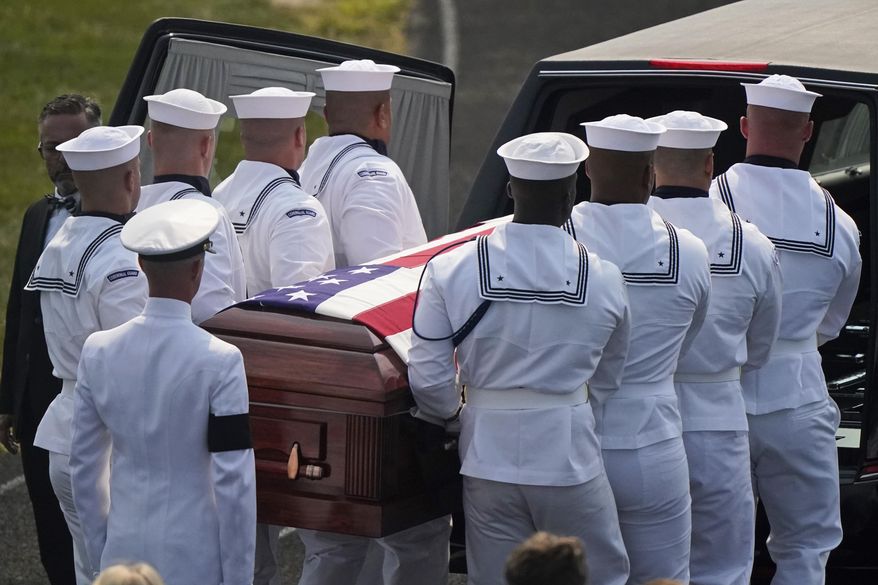 The body of Navy Corpsman Maxton Soviak is put into the hearse at Edison High School Stadium, Monday, Sept. 13, 2021, in Milan, Ohio. Soviak was one of 13 U.S. troops killed in a suicide bombing at Afghanistan's Kabul airport on Aug. 26. (AP Photo/Tony Dejak)