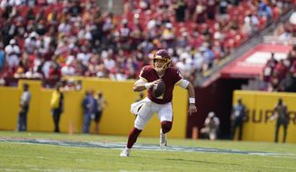 Washington Football Team quarterback Taylor Heinicke (4) running with the ball during the first half of an NFL football game against the Los Angeles Chargers, Sunday, Sept. 12, 2021, in Landover, Md. (AP Photo/Alex Brandon)