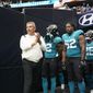 Jacksonville Jaguars coach Urban Meyer, left, prepares to lead his team onto the field before an NFL football game against the Houston Texans Sunday, Sept. 12, 2021, in Houston. (AP Photo/Sam Craft) **FILE**