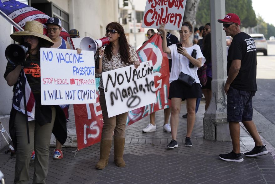 Anti-vaccine mandate protesters rally outside the garage doors of the Los Angeles Unified School District, LAUSD headquarters in Los Angeles Thursday Sept. 9, 2021. (AP Photo/Damian Dovarganes) ** FILE **
