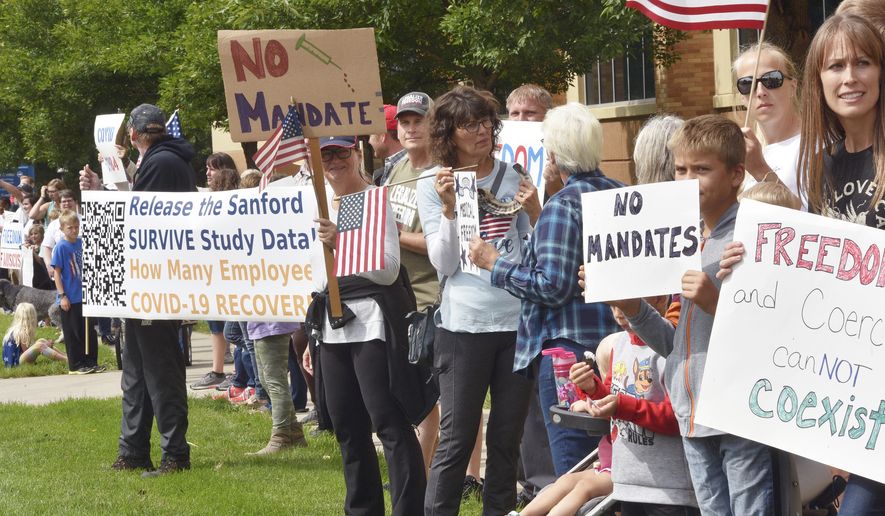 People protest against Sanford Hospital&#39;s COVID-19 vaccine mandate Tuesday, Sept. 14, 2021 in Sioux Falls, S.D. (Annie Todd/The Argus Leader via AP)