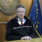 Alaska Gov. Mike Dunleavy looks up at a reporter during a press briefing on Tuesday, Sept. 14, 2021, in Juneau, Alaska. Tuesday marked the last day of the third special session of the year. (AP Photo/Becky Bohrer)