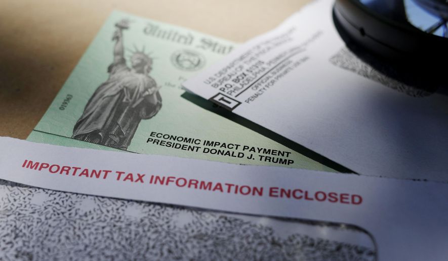 In this April 23, 2020, photo, President Donald Trump&#39;s name is seen on a stimulus check issued by the IRS to help combat the adverse economic effects of the COVID-19 outbreak, in San Antonio. (AP Photo/Eric Gay) **FILE**