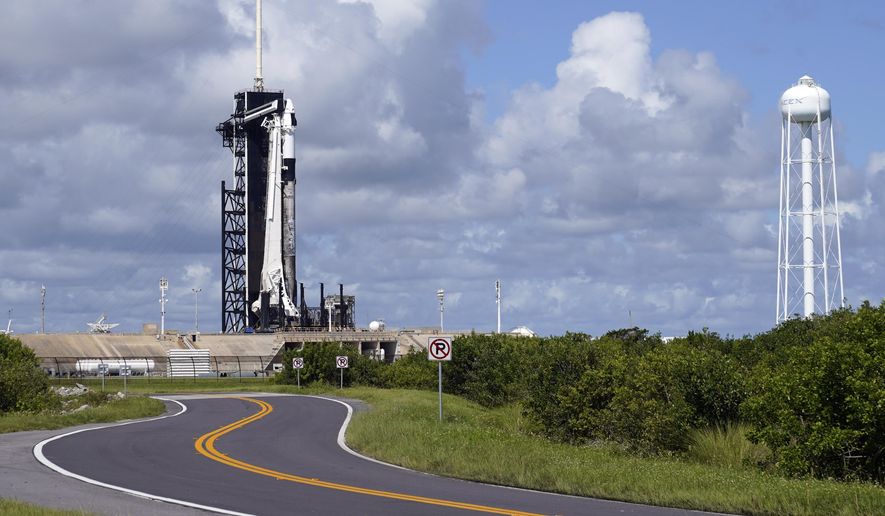 A SpaceX Falcon 9 rocket sits on pad 39A at the Kennedy Space Center in Cape Canaveral, Fla., Wednesday, Sept. 15, 2021. For the first time in 60 years of human spaceflight, a rocket is poised to blast into orbit with no professional astronauts on board, only four tourists. (AP Photo/John Raoux)