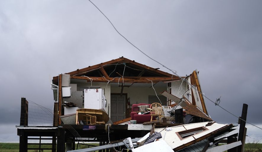 Storm clouds from Tropical Storm Nicholas are seen behind a home that was destroyed by Hurricane Ida, in Pointe-aux-Chenes, La., Tuesday, Sept. 14, 2021. (AP Photo/Gerald Herbert) 985-850-1149