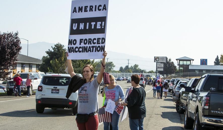 Randi Oberg, of Mountain Home, holds a sign in protest of vaccine mandates as hundreds demonstrated during a visit by President Joe Biden near the Boise, Idaho, airport, Monday, Sept. 13, 2021. (Darin Oswald/Idaho Statesman via AP) **FILE**
