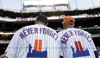 New York Mets fans wear jerseys to remember the 20th anniversary of the 9/11 terrorist attacks before a baseball game against the New York Yankees on Saturday, Sept. 11, 2021, in New York. (AP Photo/Adam Hunger)