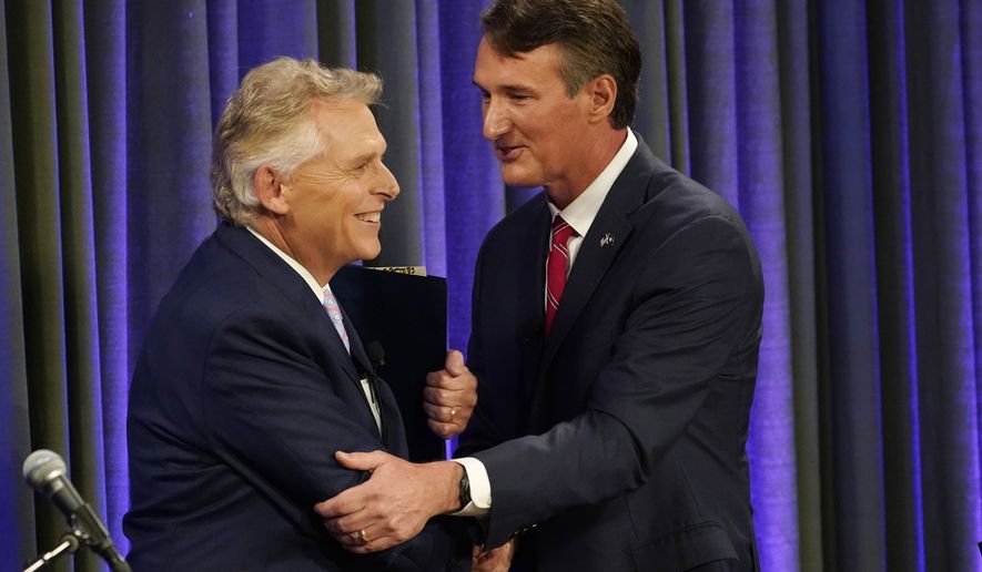 Democratic gubernatorial candidate and former governor Terry McAuliffe, left, greets his Republican challenger, Glenn Youngkin, after a debate at the Appalachian School of Law in Grundy, Va., Thursday, Sept. 16, 2021. (AP Photo/Steve Helber)