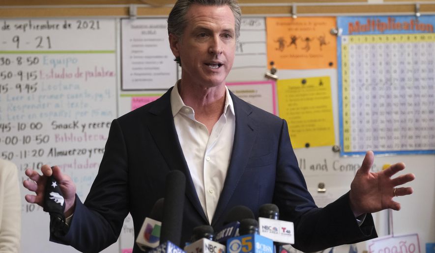 Gov. Gavin Newsom speaks to the press after visiting with students at Melrose Leadership Academy, a TK-8 school in Oakland, Calif., on Wednesday, Sept. 15, 2021, one day after defeating a Republican-led recall effort. (AP Photo/Nick Otto)