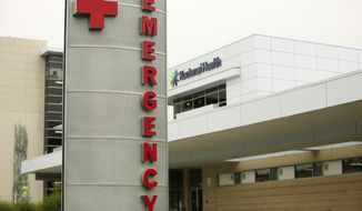 In this Sept. 10, 2021 file photo an emergency department sign is photographed in Coeur d&#39;Alene, Idaho. The first child in Virginia has died from the multisystem inflammatory syndrome associated with COVID-19 in children, the state Department of Health reported Friday. (AP Photo/Young Kwak,File)
