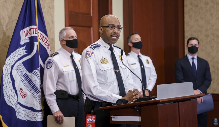 Washington Metropolitan Police Chief of Police Robert Contee, center, is joined by U.S. Capitol Police Chief Tom Manger, left, and others during a news conference to discuss preparations for a weekend rally planned by allies of Donald Trump who support the so-called &quot;political prisoners&quot; of the Jan. 6 attack on the Capitol, Friday, Sept. 17, 2021, at the Capitol in Washington, (AP Photo/J. Scott Applewhite)