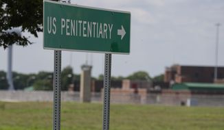 In this July 17, 2020, photo, the federal prison complex in Terre Haute, Ind. The Justice Department is reviewing its policies on housing transgender inmates in the federal prison system after protections for transgender prisoners were rolled back in the Trump administration, The Associated Press has learned. (AP Photo/Michael Conroy) **FILE**