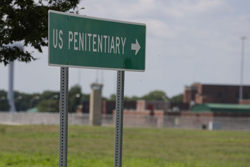 In this July 17, 2020, photo, the federal prison complex in Terre Haute, Ind. The Justice Department is reviewing its policies on housing transgender inmates in the federal prison system after protections for transgender prisoners were rolled back in the Trump administration, The Associated Press has learned. (AP Photo/Michael Conroy) **FILE**