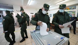 Russian Army soldiers cast their ballots during the State Duma, the Lower House of the Russian Parliament and local parliaments elections at a polling station outside St. Petersburg, Russia, Friday, Sept. 17, 2021. Russia has begun three days of voting for a new parliament that is unlikely to change the country&#39;s political complexion. There&#39;s no expectation that United Russia, the party devoted to President Vladimir Putin, will lose its dominance in the State Duma. (AP Photo/Dmitri Lovetsky)