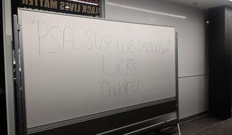 In this Sept. 16, 2021 photo courtesy of Cuyler Dunn shows a message on a white board at Lawrence High School in Lawernce, Kan., that says PSA Stop the Devious Licks Children. Students across the country are videoing themselves stealing soap dispensers, microscopes and even turf off stadium football fields and posting their heists on TikTok in a phenomenon dubbed &amp;quot;devious licks&amp;quot; that is bedeviling administrators and forcing them to shut down bathrooms. (Cuyler Dunn via AP)