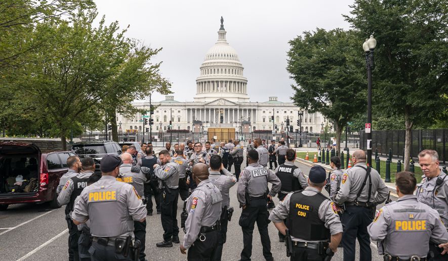 Police stage at a security fence ahead of a rally near the U.S. Capitol in Washington, Saturday, Sept. 18, 2021. The rally was planned by allies of former President Donald Trump and aimed at supporting the so-called &quot;political prisoners&quot; of the Jan. 6 storming of the U.S. Capitol. (AP Photo/Nathan Howard)  **FILE**