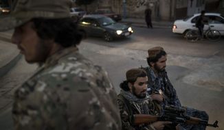 Taliban fighters ride in the back of a pickup truck as patrol the streets of Kabul, Afghanistan, Saturday, Sept. 18, 2021. (AP Photo/Felipe Dana)